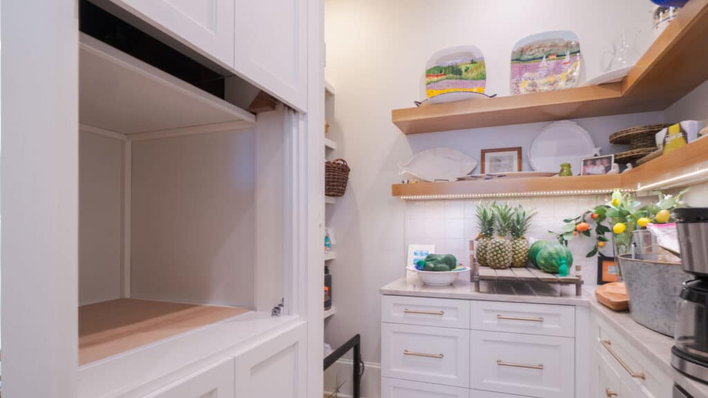 Photo of a brand new pantry with a custom dumbwaiter built by lanphear builders